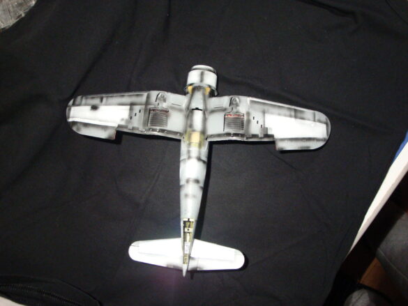 "Heavily weathered underside of F4U-1 Corsair 126 with realistic oil and dust effects simulating coral strip operations".