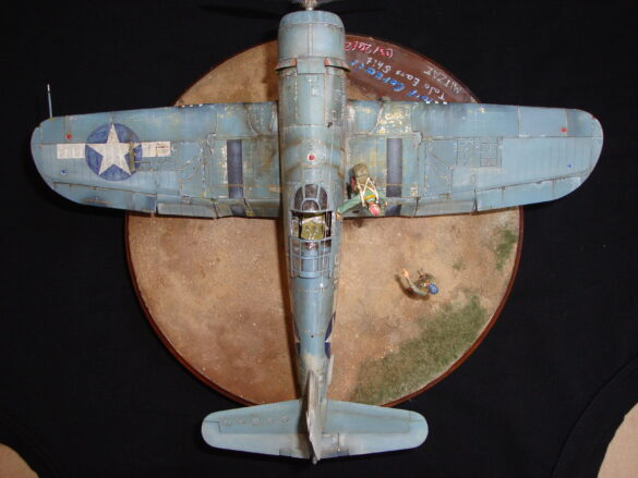 "Heavily weathered underside of F4U-1 Corsair 126 with realistic oil and dust effects simulating coral strip operations".