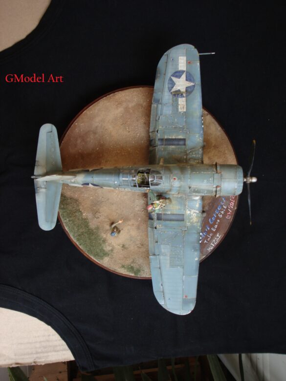 "Heavily weathered underside of F4U-1 Corsair 126 with realistic oil and dust effects simulating coral strip operations".
