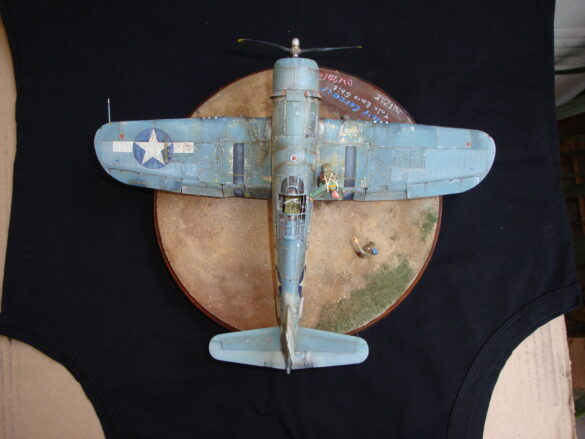 "Heavily weathered underside of F4U-1 Corsair 126 with realistic oil and dust effects simulating coral strip operations".