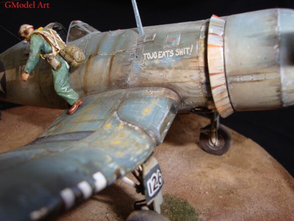 "Heavily weathered underside of F4U-1 Corsair 126 with realistic oil and dust effects simulating coral strip operations".