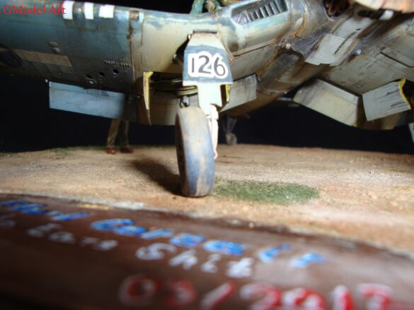 "Heavily weathered underside of F4U-1 Corsair 126 with realistic oil and dust effects simulating coral strip operations".