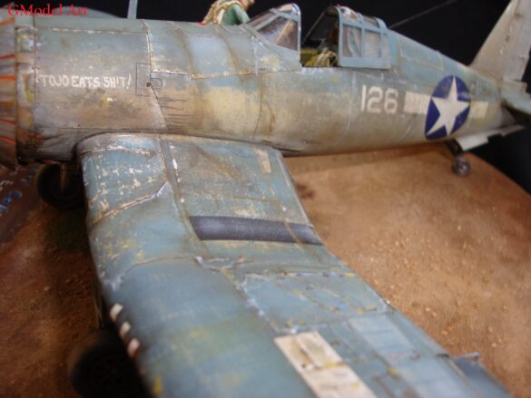 "Heavily weathered underside of F4U-1 Corsair 126 with realistic oil and dust effects simulating coral strip operations".