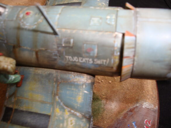 "Heavily weathered underside of F4U-1 Corsair 126 with realistic oil and dust effects simulating coral strip operations".