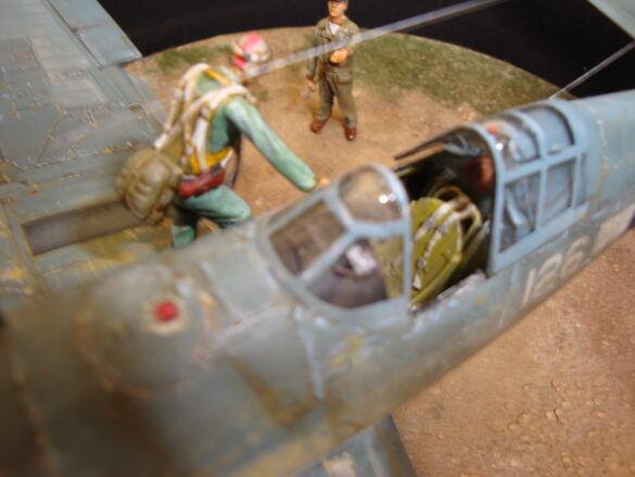 "Heavily weathered underside of F4U-1 Corsair 126 with realistic oil and dust effects simulating coral strip operations".