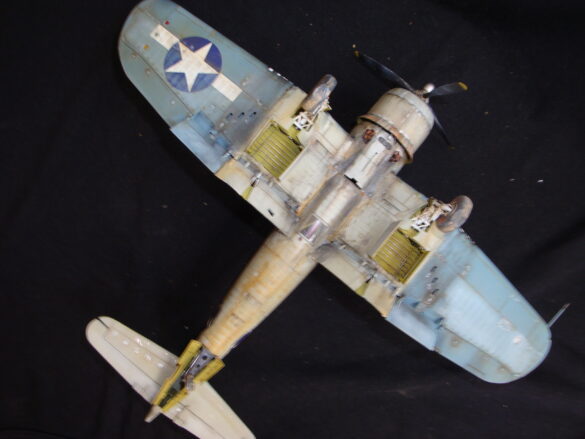 "Heavily weathered underside of F4U-1 Corsair 126 with realistic oil and dust effects simulating coral strip operations".