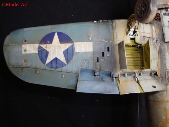 "Heavily weathered underside of F4U-1 Corsair 126 with realistic oil and dust effects simulating coral strip operations".