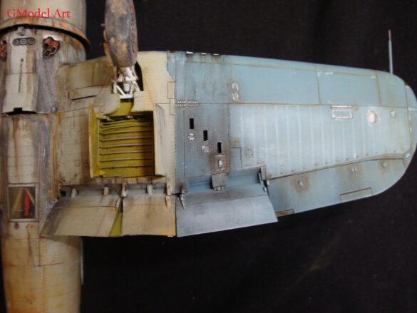 "Heavily weathered underside of F4U-1 Corsair 126 with realistic oil and dust effects simulating coral strip operations".