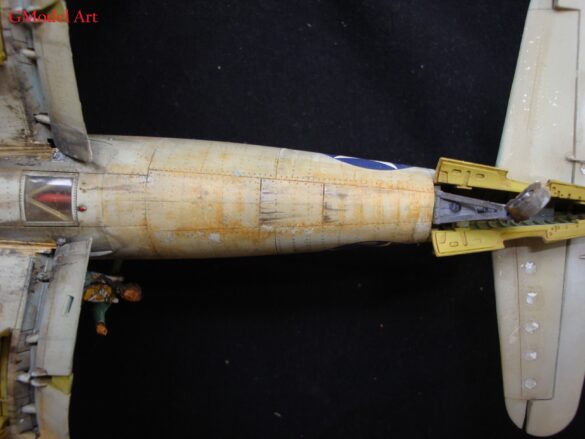 "Heavily weathered underside of F4U-1 Corsair 126 with realistic oil and dust effects simulating coral strip operations".