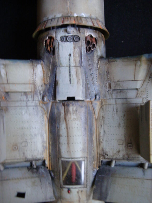 "Heavily weathered underside of F4U-1 Corsair 126 with realistic oil and dust effects simulating coral strip operations".