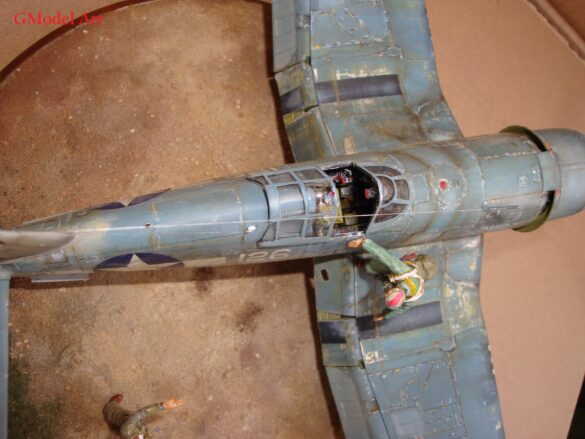 "Heavily weathered underside of F4U-1 Corsair 126 with realistic oil and dust effects simulating coral strip operations".