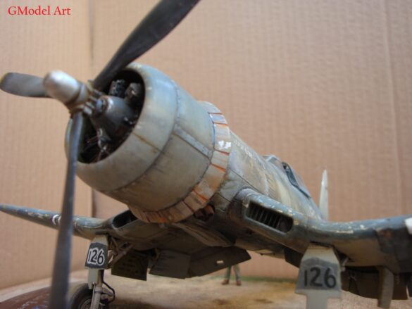 "Heavily weathered underside of F4U-1 Corsair 126 with realistic oil and dust effects simulating coral strip operations".