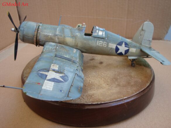 "Heavily weathered underside of F4U-1 Corsair 126 with realistic oil and dust effects simulating coral strip operations".