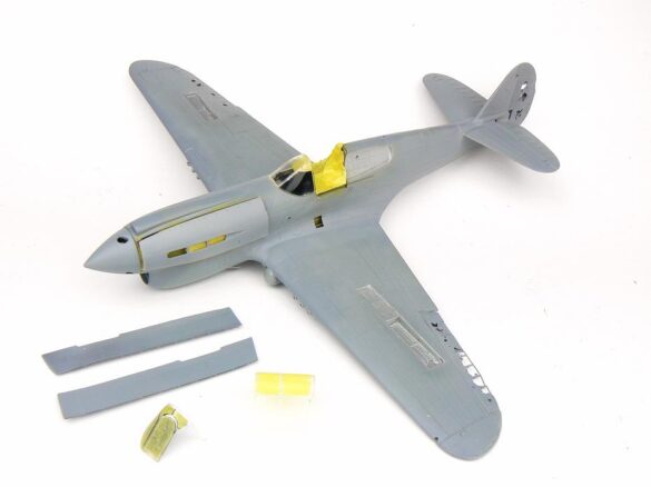 1/48 P-40M RNZAF scale model with open panels and detailed interior, expertly weathered to represent a derelict aircraft.”