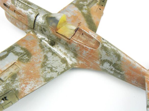 1/48 P-40M RNZAF scale model with open panels and detailed interior, expertly weathered to represent a derelict aircraft.”