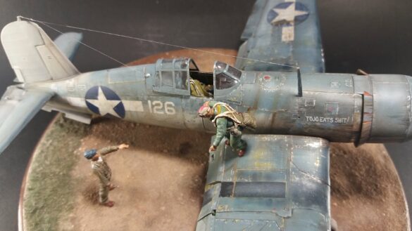 "Heavily weathered underside of F4U-1 Corsair 126 with realistic oil and dust effects simulating coral strip operations".