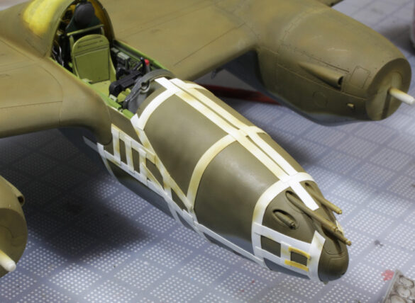 Photo Gallery – Tamiya 1/48 P-38G Lightning by Chris Wauchop Radio compartment detailing using 0.2 mm and 0.3 mm wire – painted placards and realistic wiring. Supercharger units finished with layered metallic and brown/black shades for realistic depth. Fuselage underside showing grime wash and added hydraulic brake lines. Drop tanks weathered for operational realism, mounted underwing. Panel line seal tape simulation using airbrush fading and masking techniques. Camouflage tones stippled for realistic weathered surface finish. Paint wear and black exhaust marks enhance visual realism. Cockpit close-up with foil-made harness and mirror wire control. Wing underside shows soot, staining, and sealing tape simulation. Tail surfaces display extensive weathering and exhaust wear effects.