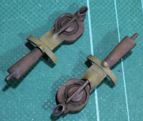 Photo Gallery – Tamiya 1/48 P-38G Lightning by Chris Wauchop Radio compartment detailing using 0.2 mm and 0.3 mm wire – painted placards and realistic wiring. Supercharger units finished with layered metallic and brown/black shades for realistic depth. Fuselage underside showing grime wash and added hydraulic brake lines. Drop tanks weathered for operational realism, mounted underwing. Panel line seal tape simulation using airbrush fading and masking techniques. Camouflage tones stippled for realistic weathered surface finish. Paint wear and black exhaust marks enhance visual realism. Cockpit close-up with foil-made harness and mirror wire control. Wing underside shows soot, staining, and sealing tape simulation. Tail surfaces display extensive weathering and exhaust wear effects.