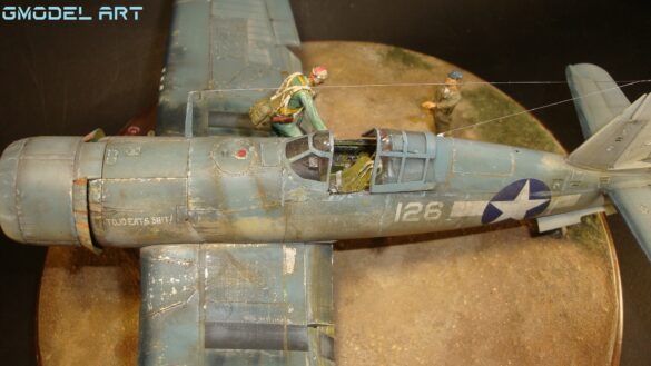 "Heavily weathered underside of F4U-1 Corsair 126 with realistic oil and dust effects simulating coral strip operations".