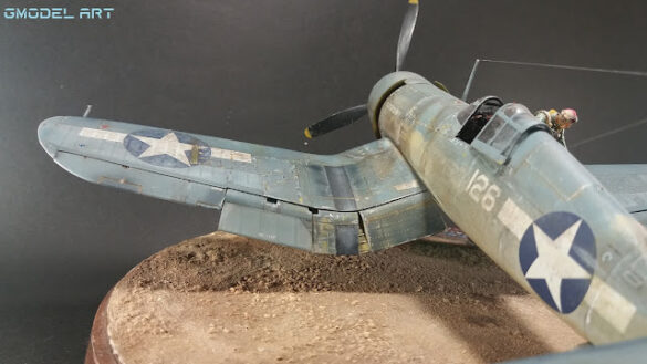 "Heavily weathered underside of F4U-1 Corsair 126 with realistic oil and dust effects simulating coral strip operations".