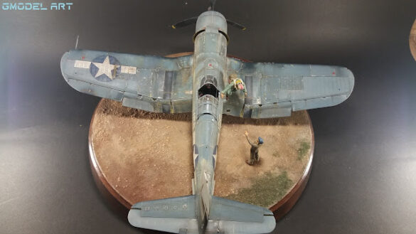 "Heavily weathered underside of F4U-1 Corsair 126 with realistic oil and dust effects simulating coral strip operations".