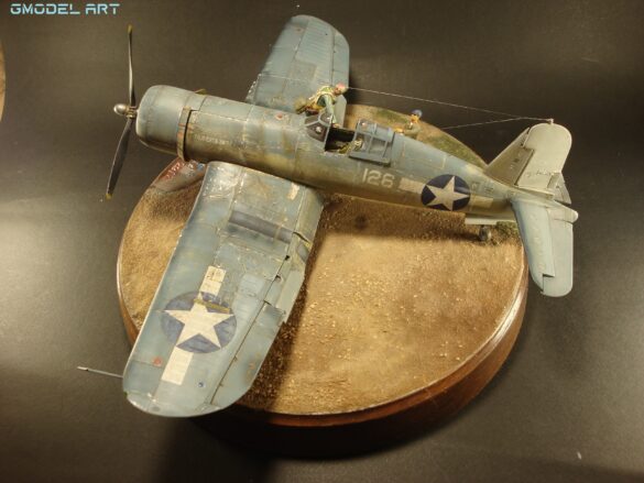 "Heavily weathered underside of F4U-1 Corsair 126 with realistic oil and dust effects simulating coral strip operations".