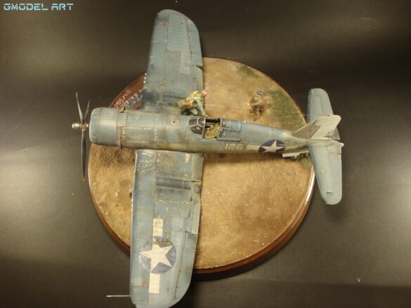 "Heavily weathered underside of F4U-1 Corsair 126 with realistic oil and dust effects simulating coral strip operations".