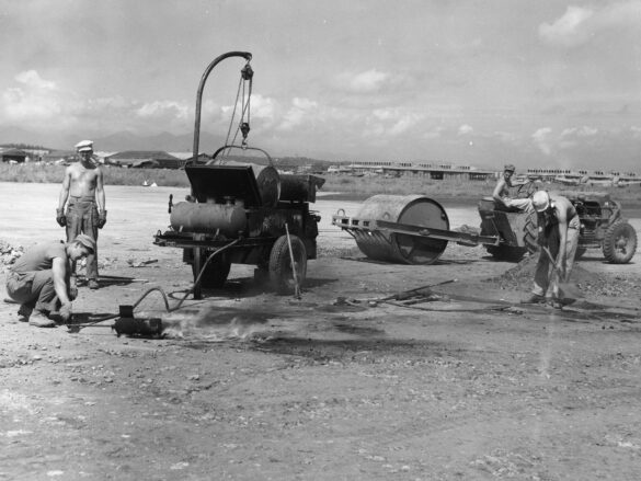 alt="1/48 scale Pacific airfield diorama with PSP and fuel truck" alt="US WW2 bomb cart and drums beside F4U Corsair" alt="Ground crew and maintenance scene on jungle runway" alt="Diorama showing GMC fuel bowser and PSP strip" alt="Scale model US bomb hoist in tropical airfield setting"