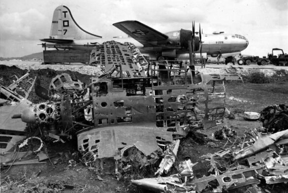alt="1/48 scale Pacific airfield diorama with PSP and fuel truck" alt="US WW2 bomb cart and drums beside F4U Corsair" alt="Ground crew and maintenance scene on jungle runway" alt="Diorama showing GMC fuel bowser and PSP strip" alt="Scale model US bomb hoist in tropical airfield setting"