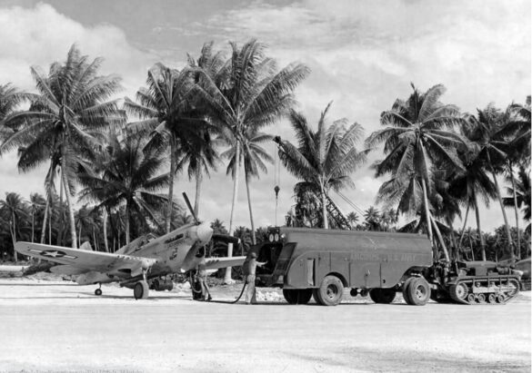 alt="1/48 scale Pacific airfield diorama with PSP and fuel truck" alt="US WW2 bomb cart and drums beside F4U Corsair" alt="Ground crew and maintenance scene on jungle runway" alt="Diorama showing GMC fuel bowser and PSP strip" alt="Scale model US bomb hoist in tropical airfield setting"