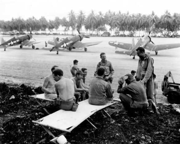 alt="1/48 scale Pacific airfield diorama with PSP and fuel truck" alt="US WW2 bomb cart and drums beside F4U Corsair" alt="Ground crew and maintenance scene on jungle runway" alt="Diorama showing GMC fuel bowser and PSP strip" alt="Scale model US bomb hoist in tropical airfield setting"