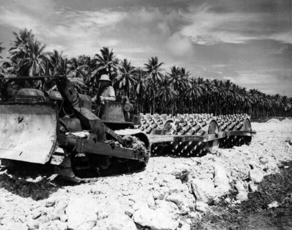 alt="1/48 scale Pacific airfield diorama with PSP and fuel truck" alt="US WW2 bomb cart and drums beside F4U Corsair" alt="Ground crew and maintenance scene on jungle runway" alt="Diorama showing GMC fuel bowser and PSP strip" alt="Scale model US bomb hoist in tropical airfield setting"