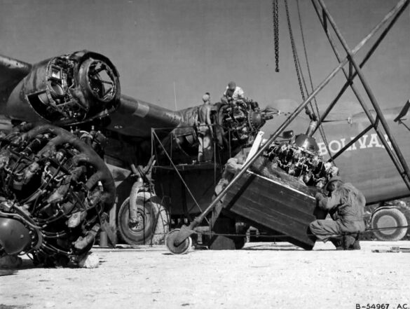 alt="1/48 scale Pacific airfield diorama with PSP and fuel truck" alt="US WW2 bomb cart and drums beside F4U Corsair" alt="Ground crew and maintenance scene on jungle runway" alt="Diorama showing GMC fuel bowser and PSP strip" alt="Scale model US bomb hoist in tropical airfield setting"