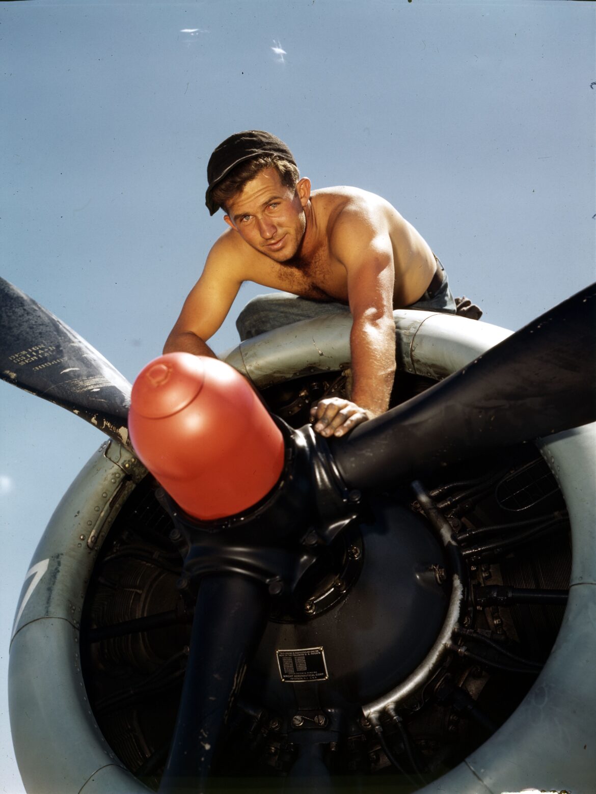 a man leaning on a propeller