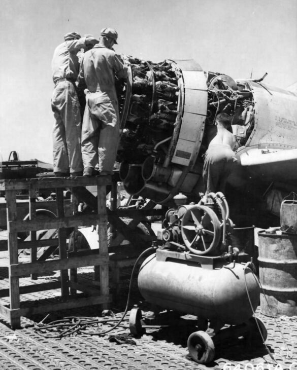 "1/48 scale Pacific airfield diorama with PSP and fuel truck" alt="US WW2 bomb cart and drums beside F4U Corsair" alt="Ground crew and maintenance scene on jungle runway" alt="Diorama showing GMC fuel bowser and PSP strip" alt="Scale model US bomb hoist in tropical airfield setting"