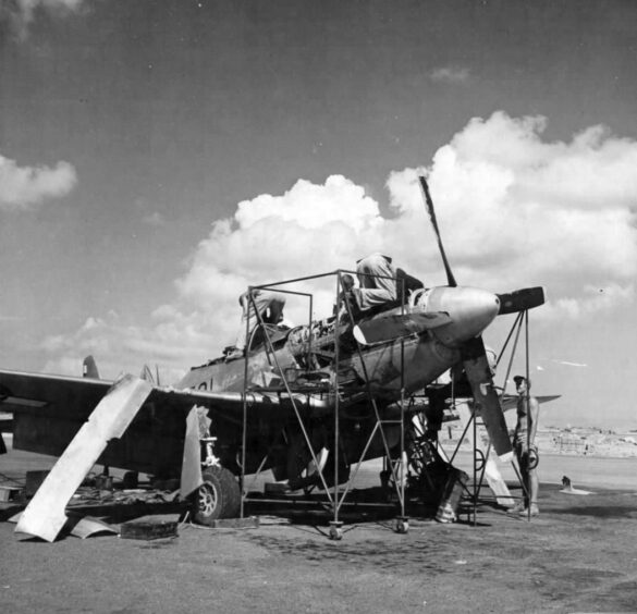 "1/48 scale Pacific airfield diorama with PSP and fuel truck" alt="US WW2 bomb cart and drums beside F4U Corsair" alt="Ground crew and maintenance scene on jungle runway" alt="Diorama showing GMC fuel bowser and PSP strip" alt="Scale model US bomb hoist in tropical airfield setting"