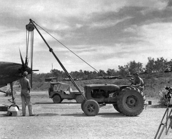 alt="1/48 scale Pacific airfield diorama with PSP and fuel truck" alt="US WW2 bomb cart and drums beside F4U Corsair" alt="Ground crew and maintenance scene on jungle runway" alt="Diorama showing GMC fuel bowser and PSP strip" alt="Scale model US bomb hoist in tropical airfield setting"
