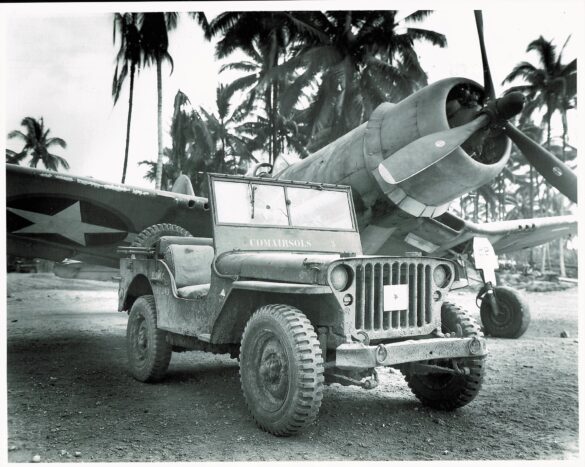alt="1/48 scale Pacific airfield diorama with PSP and fuel truck" alt="US WW2 bomb cart and drums beside F4U Corsair" alt="Ground crew and maintenance scene on jungle runway" alt="Diorama showing GMC fuel bowser and PSP strip" alt="Scale model US bomb hoist in tropical airfield setting"