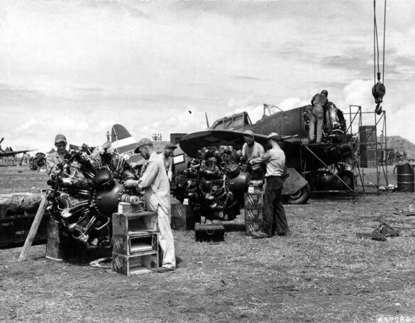 alt="1/48 scale Pacific airfield diorama with PSP and fuel truck" alt="US WW2 bomb cart and drums beside F4U Corsair" alt="Ground crew and maintenance scene on jungle runway" alt="Diorama showing GMC fuel bowser and PSP strip" alt="Scale model US bomb hoist in tropical airfield setting"