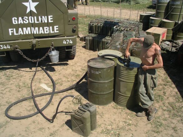 alt="1/48 scale Pacific airfield diorama with PSP and fuel truck" alt="US WW2 bomb cart and drums beside F4U Corsair" alt="Ground crew and maintenance scene on jungle runway" alt="Diorama showing GMC fuel bowser and PSP strip" alt="Scale model US bomb hoist in tropical airfield setting"