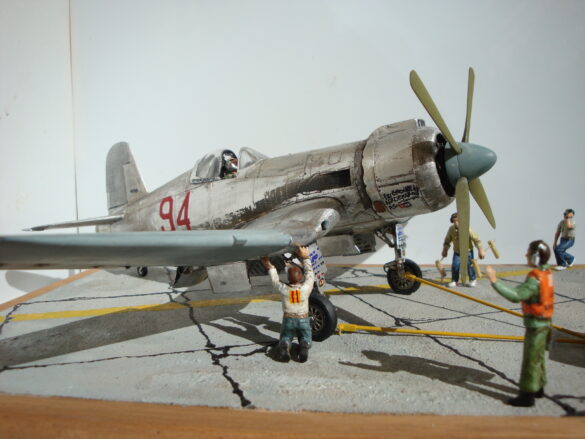 FG-1D Corsair #94-“Big Hummer” at Reno 1971 / Pilot ~ Bob Mitchem. FG-1D Corsair “Big Hammer” – 1/48 model with aluminum foil skin, four-blade prop, Hasegawa carrier crew figures, and scratch-built diorama base, depicting a Reno 1971 scene.