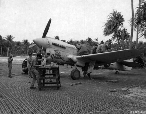 alt="1/48 scale Pacific airfield diorama with PSP and fuel truck" alt="US WW2 bomb cart and drums beside F4U Corsair" alt="Ground crew and maintenance scene on jungle runway" alt="Diorama showing GMC fuel bowser and PSP strip" alt="Scale model US bomb hoist in tropical airfield setting"