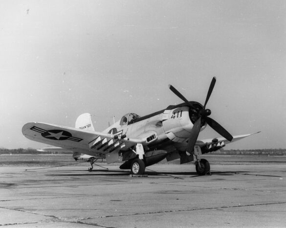 “Vought AU-1 Corsair in Light Gull Gray over Insignia White parked at NAS North Island, January 1956 – side profile with underwing pylons visible.”