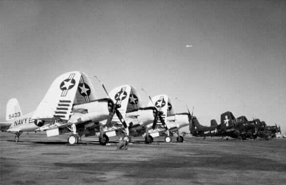 “Vought AU-1 Corsair in Light Gull Gray over Insignia White parked at NAS North Island, January 1956 – side profile with underwing pylons visible.”