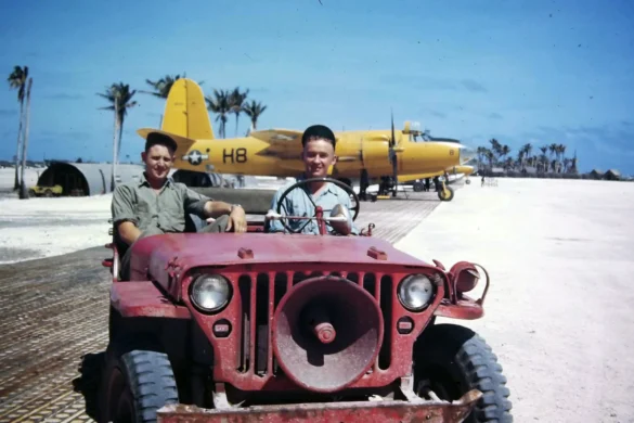 alt="1/48 scale Pacific airfield diorama with PSP and fuel truck" alt="US WW2 bomb cart and drums beside F4U Corsair" alt="Ground crew and maintenance scene on jungle runway" alt="Diorama showing GMC fuel bowser and PSP strip" alt="Scale model US bomb hoist in tropical airfield setting"