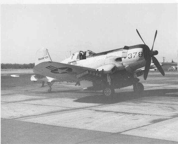“Vought AU-1 Corsair in Light Gull Gray over Insignia White parked at NAS North Island, January 1956 – side profile with underwing pylons visible.”