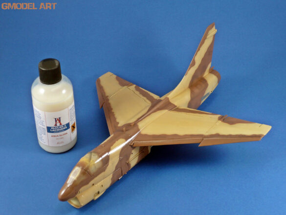 Model airplane with paint bottle