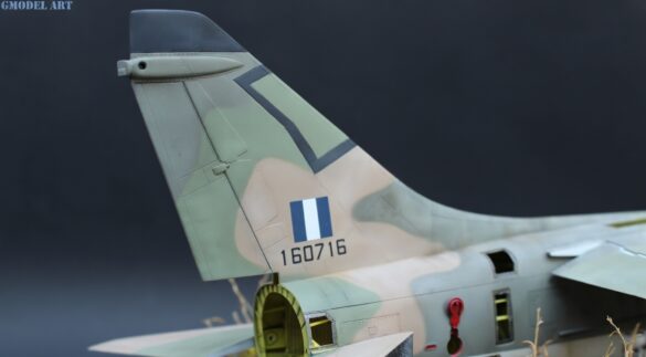 Weathered Hellenic Air Force A-7E Corsair cemetery model with faded camouflage and open maintenance panels.