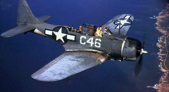 Weathered Douglas SBD Dauntless White C 46 showing faded Blue Gray camouflage and replacement cowling during a training flight.