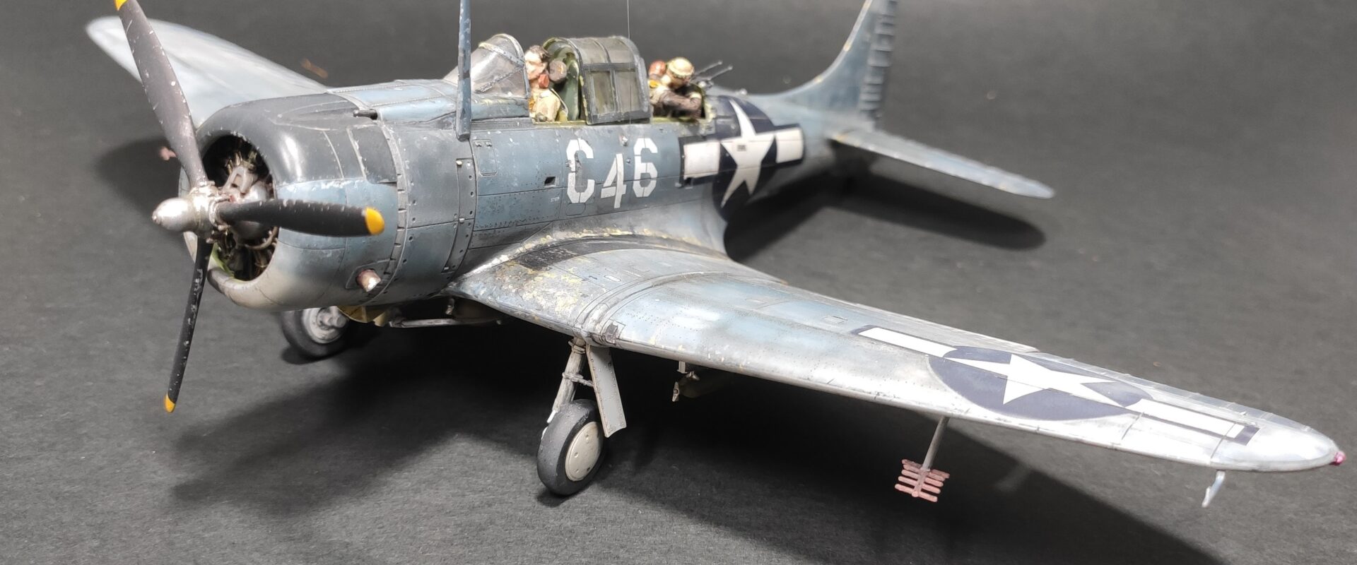 1/48 scale model of SBD Dauntless White C 46 with heavily weathered Pacific camouflage and faded Blue Gray paint scheme.